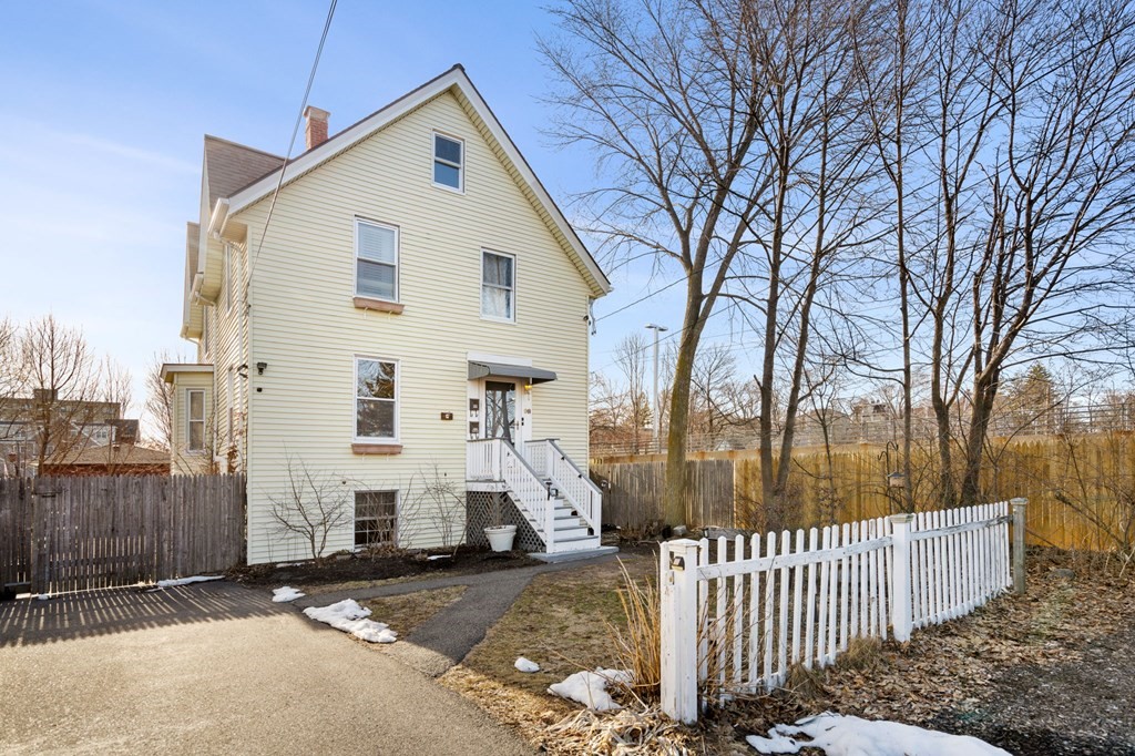 98 Pine Street Swampscott, MA 01907 - Photo 26 of 37 a view of a house with wooden fence next to a road