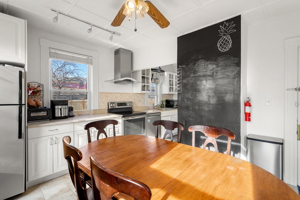 98 Pine Street Swampscott, MA 01907 - Photo 8 of 37 a dining room with stainless steel appliances a table and chairs