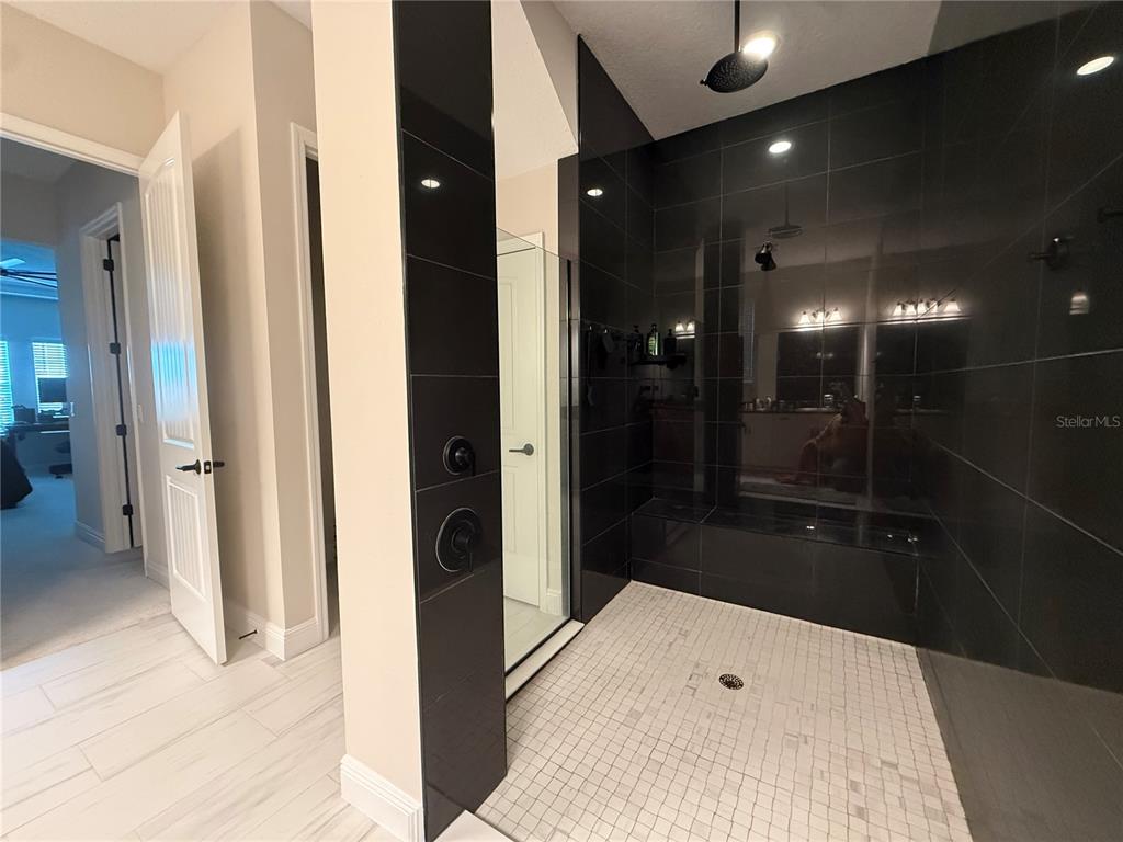 10958 Rustic Timber Loop San Antonio, FL 33576 - Photo 31 of 48 a bathroom with a sink and shower