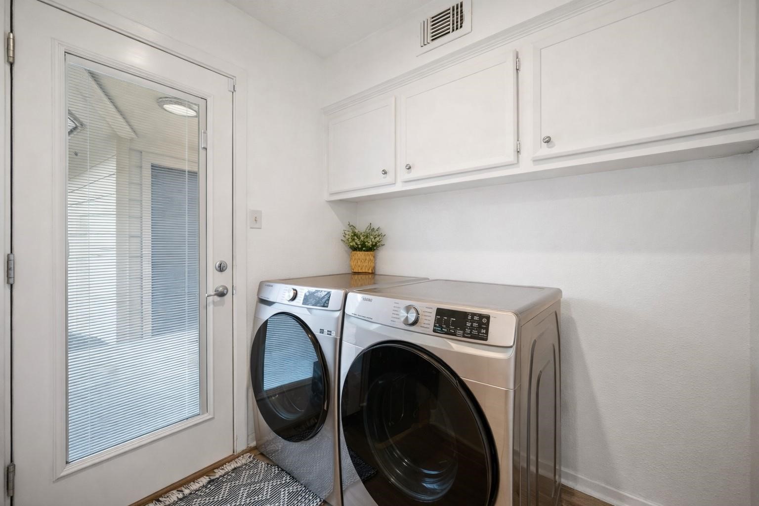 14907 Oak Bluff Court Houston, TX 77070 - Photo 12 of 19 Spacious utility room with built-in storage and convenient workspace.