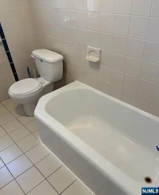 278 High Street Hackensack, NJ 07601 - Photo 13 of 16 a white toilet sitting next to a bath tub