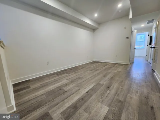 a view of a room with wooden floor