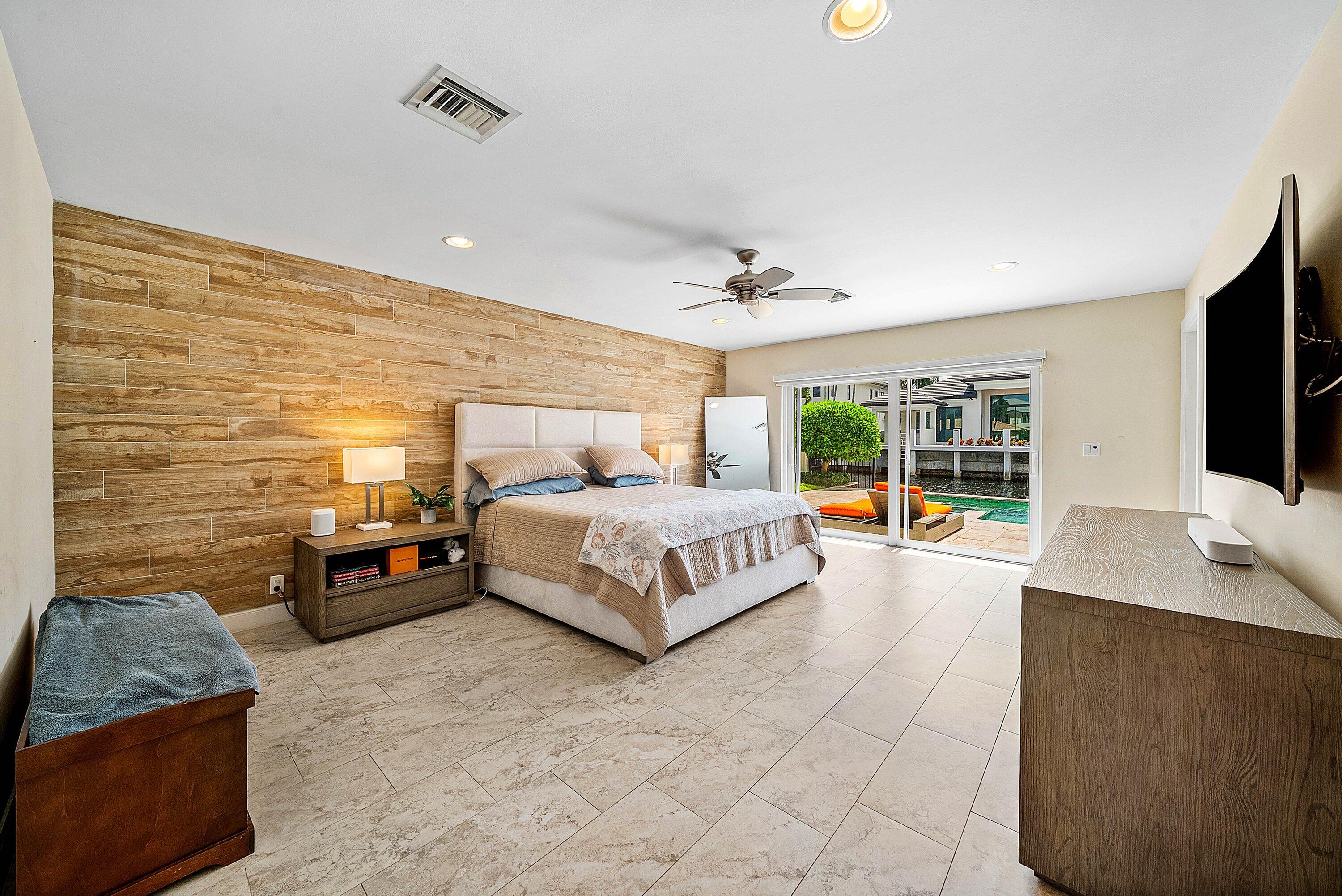 740 Northeast 36th Street Boca Raton, FL 33431 - Photo 17 of 50 a bedroom with a bed and a flat screen television