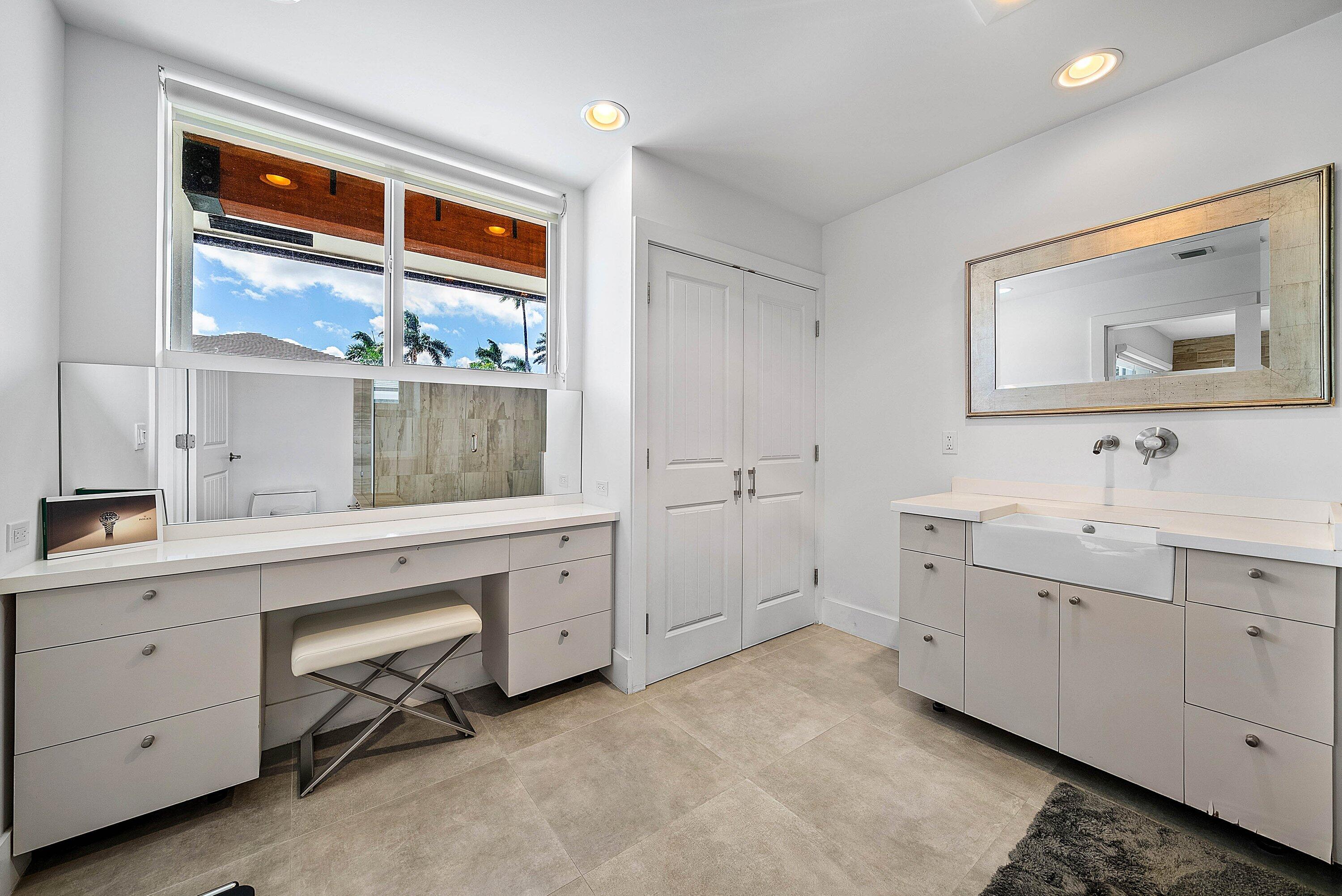 740 Northeast 36th Street Boca Raton, FL 33431 - Photo 19 of 50 a spacious bathroom with double vanity sink a two mirror a window and a bathtub