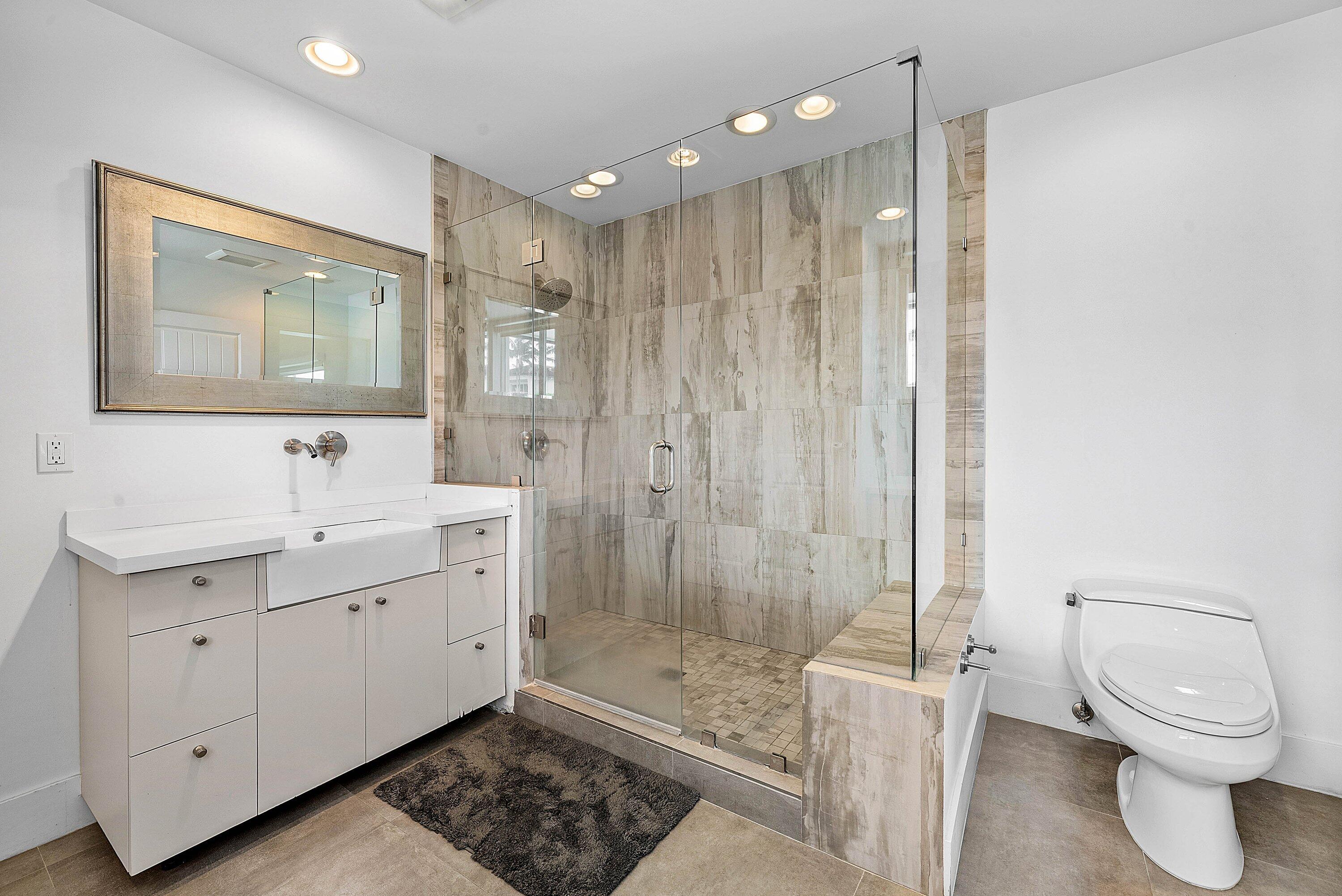 740 Northeast 36th Street Boca Raton, FL 33431 - Photo 20 of 50 a bathroom with a toilet a sink and shower