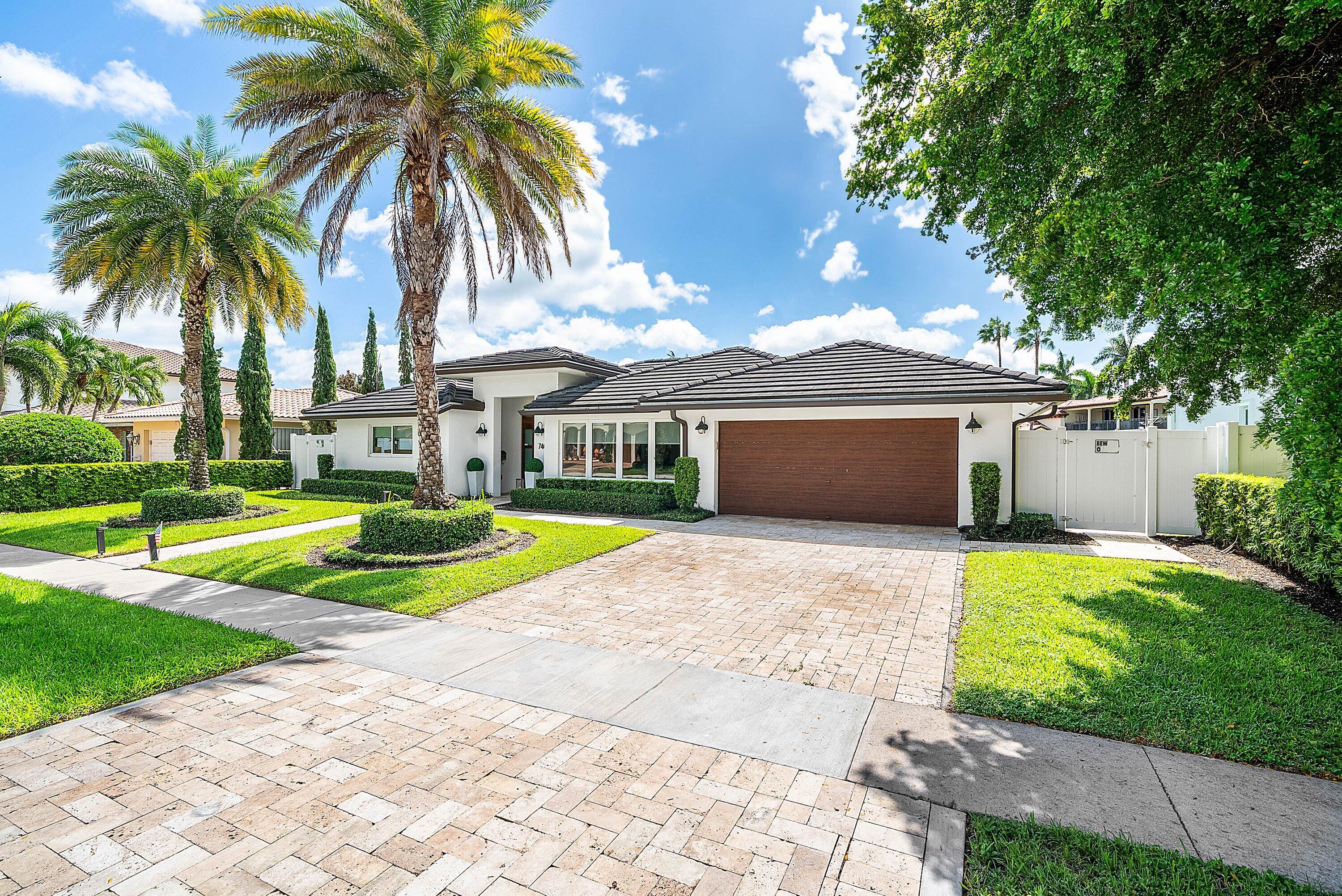 740 Northeast 36th Street Boca Raton, FL 33431 - Photo 2 of 50 a front view of house with yard and swimming pool