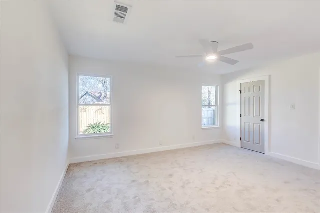 an empty room with windows and closet