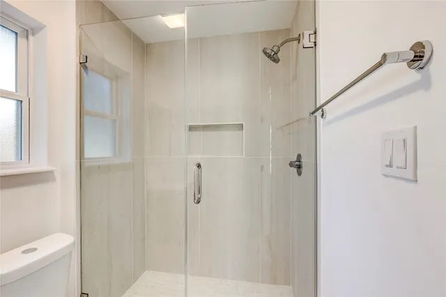 a bathroom with a shower and toilet