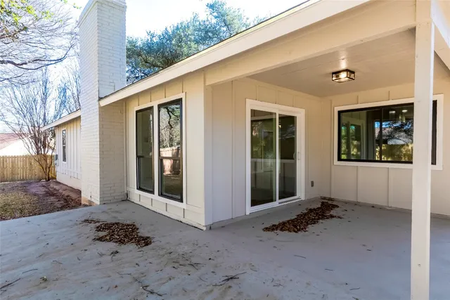 a front view of a house with a tree