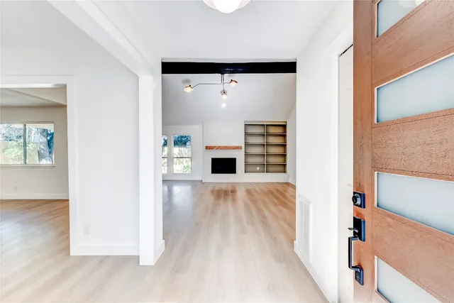 a view of a livingroom with wooden floor and staircase