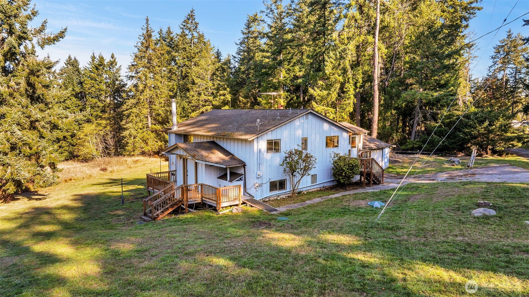 a view of a house with yard and sitting area