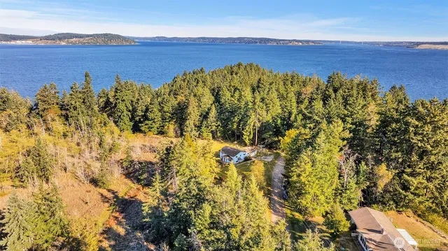 an aerial view of a house with a big yard
