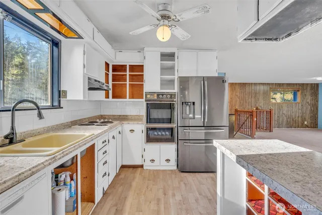 a kitchen with a stove a sink and a refrigerator