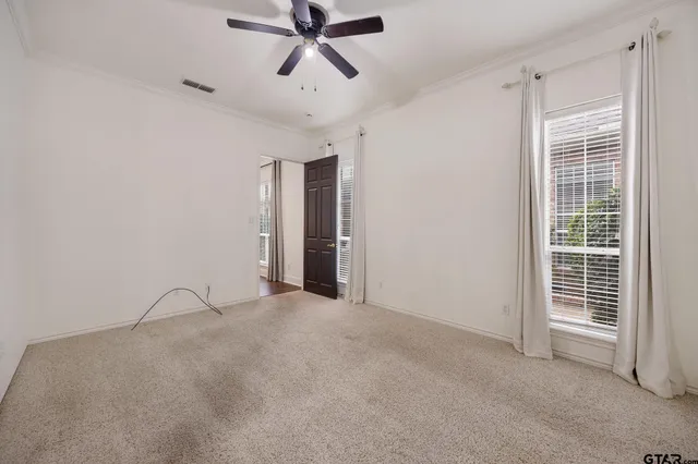 a view of a livingroom with a ceiling fan and window