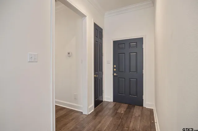 a view of hallway with wooden floor