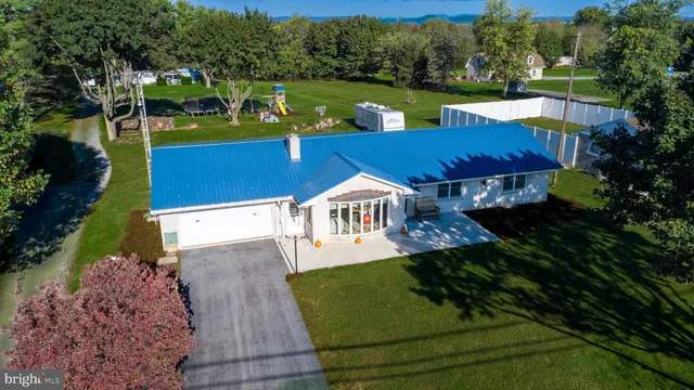 an aerial view of a house with swimming pool garden and patio