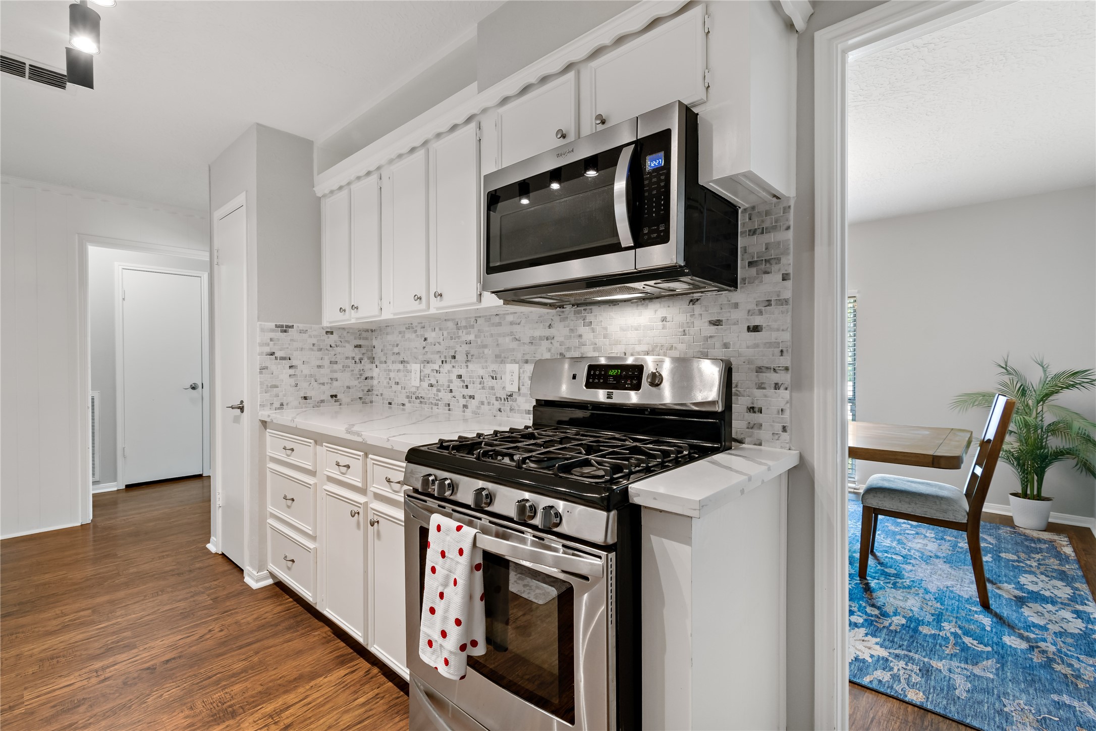4302 Seneca Street Pasadena, TX 77504 - Photo 4 of 19 a kitchen with stainless steel appliances granite countertop a stove and a microwave