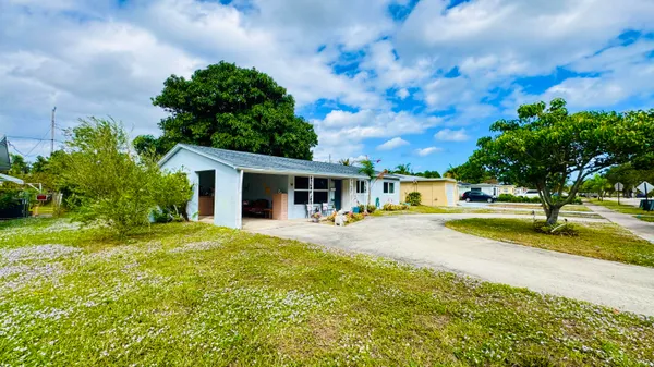 a view of a house with swimming pool and sitting area