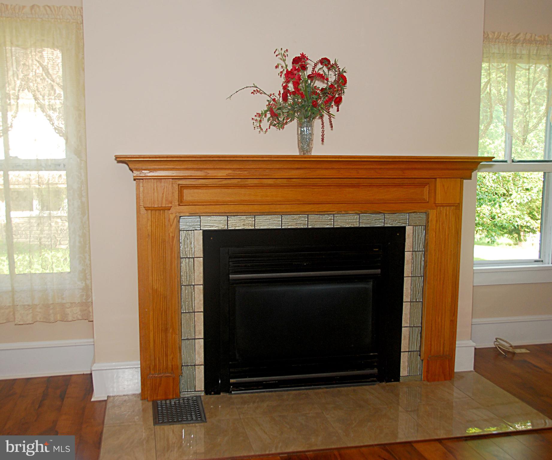 121 Chesterville Road Landenberg, PA 19350 - Photo 12 of 35 a living room with a fireplace and a window