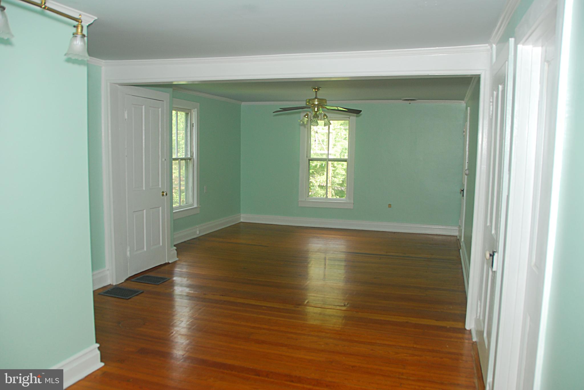 121 Chesterville Road Landenberg, PA 19350 - Photo 27 of 35 a view of an empty room with wooden floor and a window