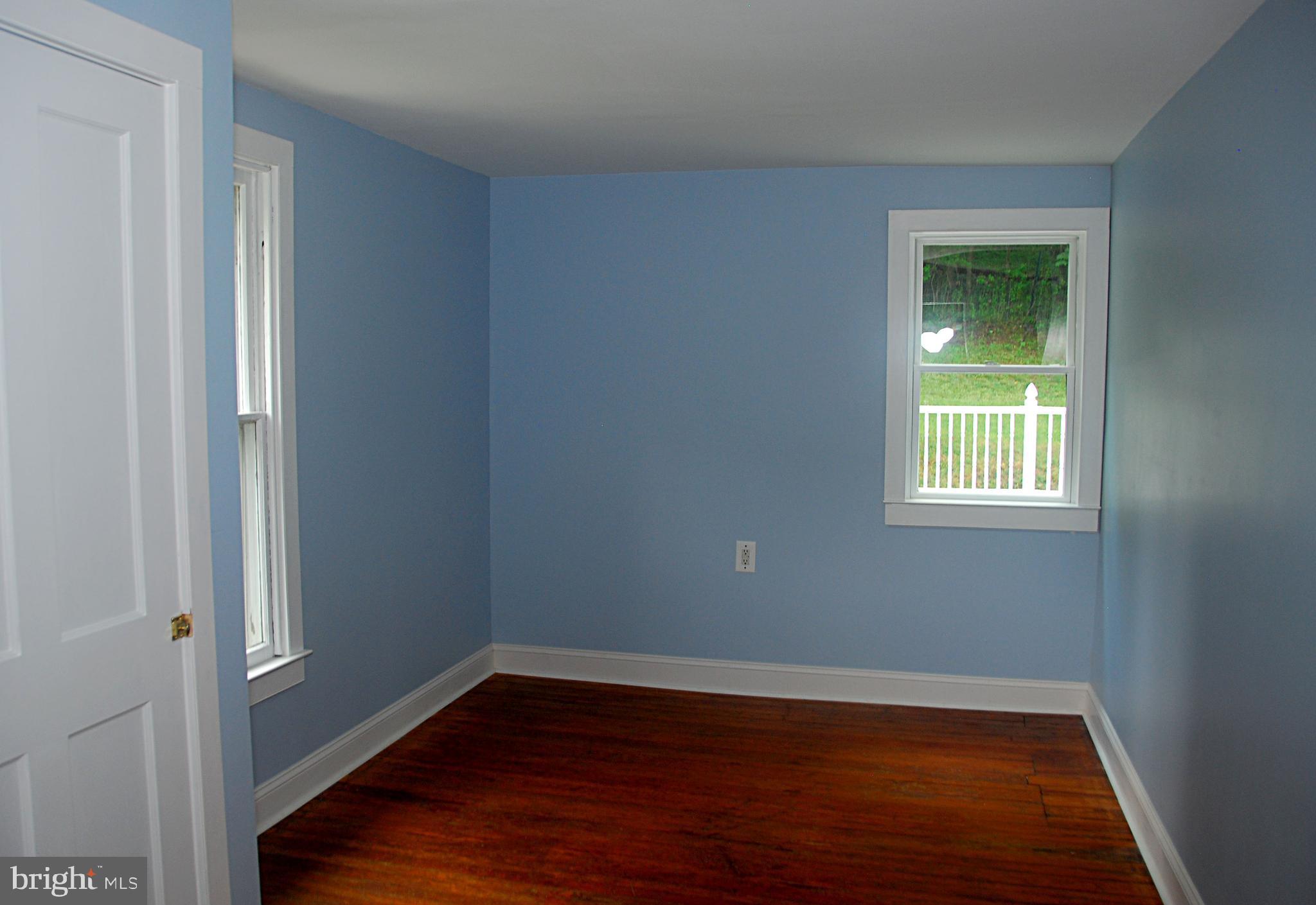 121 Chesterville Road Landenberg, PA 19350 - Photo 30 of 35 a view of an empty room with wooden floor and a window