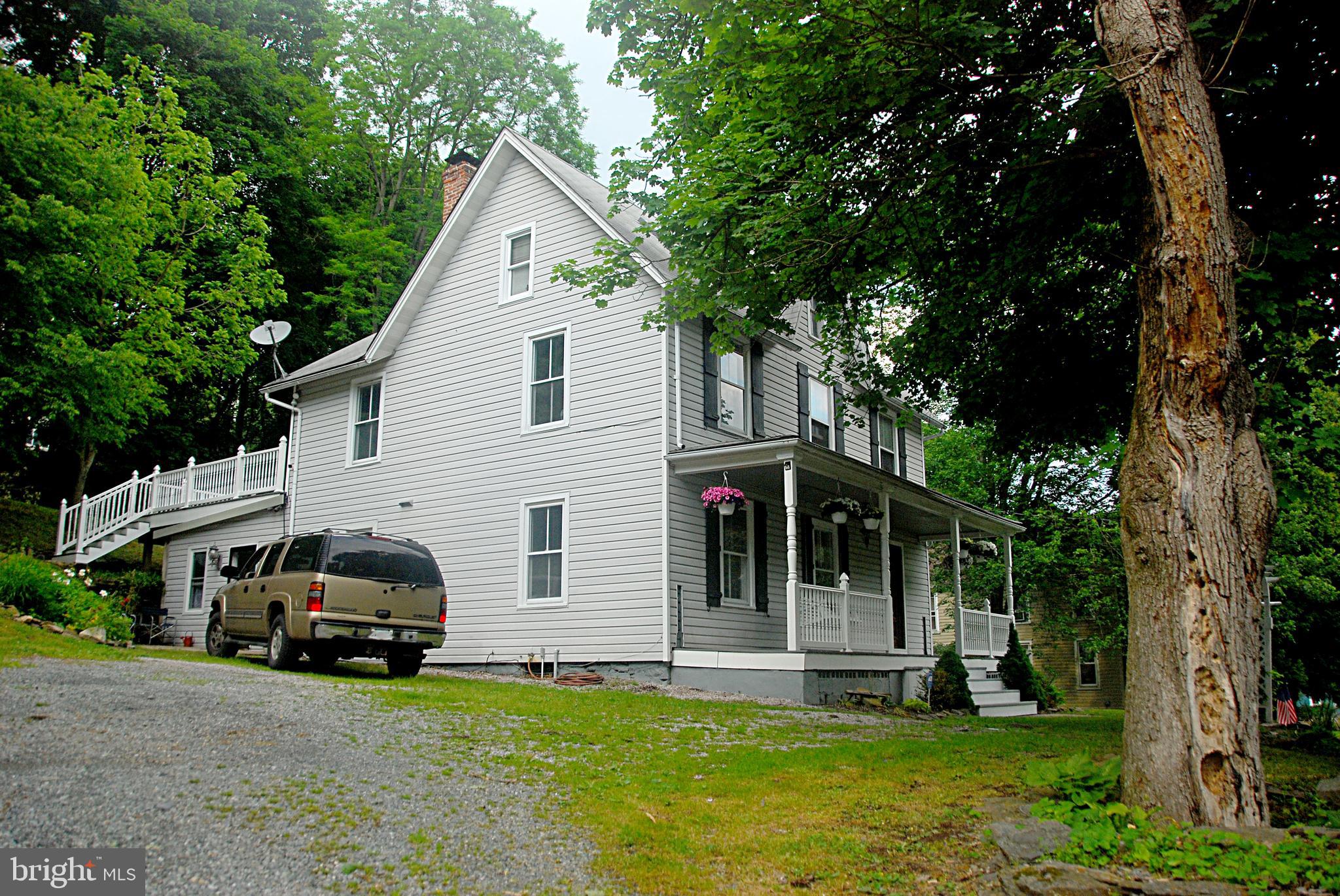 121 Chesterville Road Landenberg, PA 19350 - Photo 4 of 35 a view of a white house with a big yard and large trees