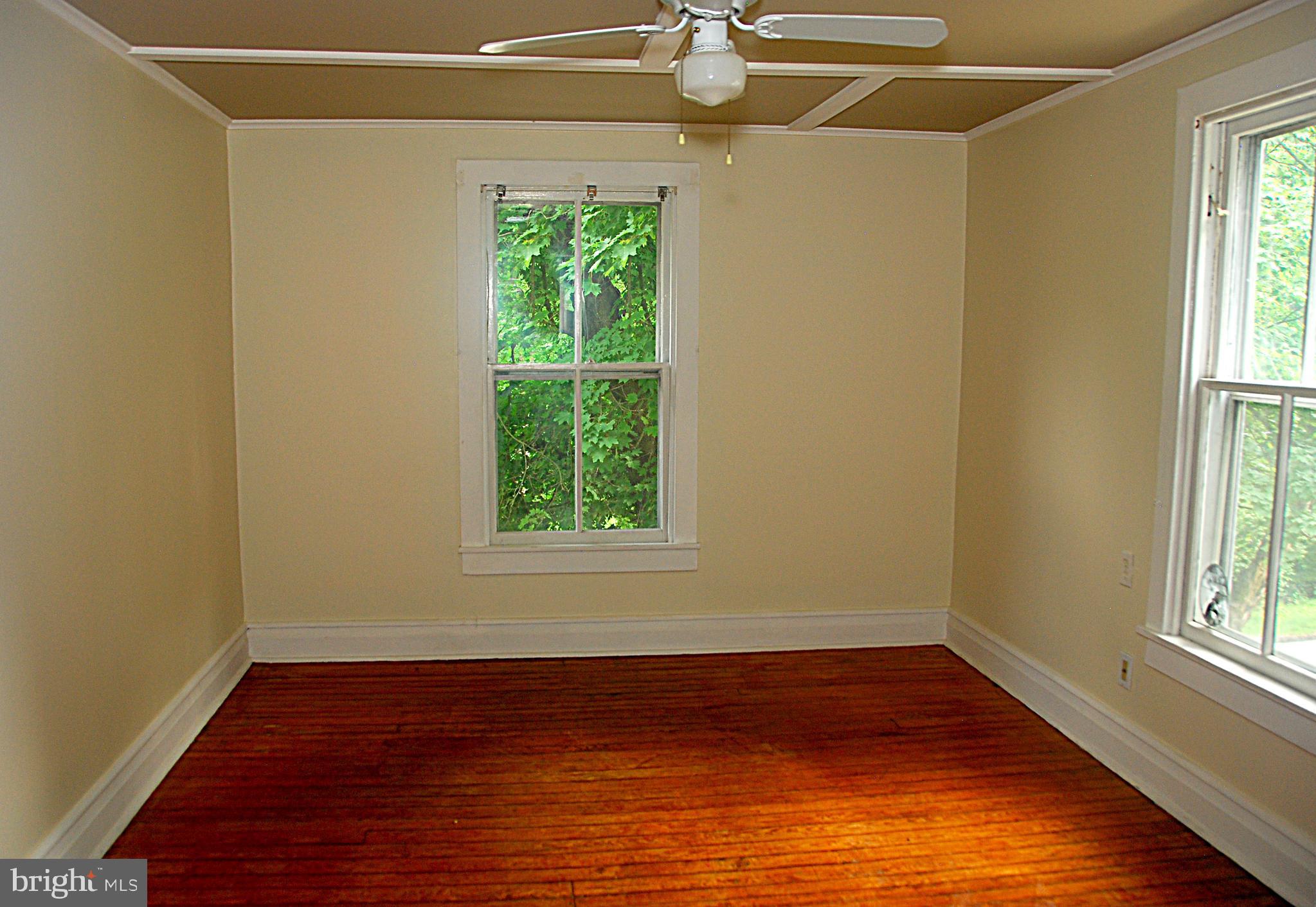 121 Chesterville Road Landenberg, PA 19350 - Photo 31 of 35 a view of an empty room with wooden floor and a window