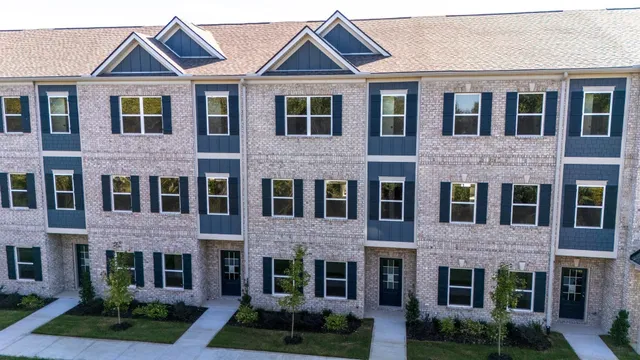 a front view of a brick house with a yard