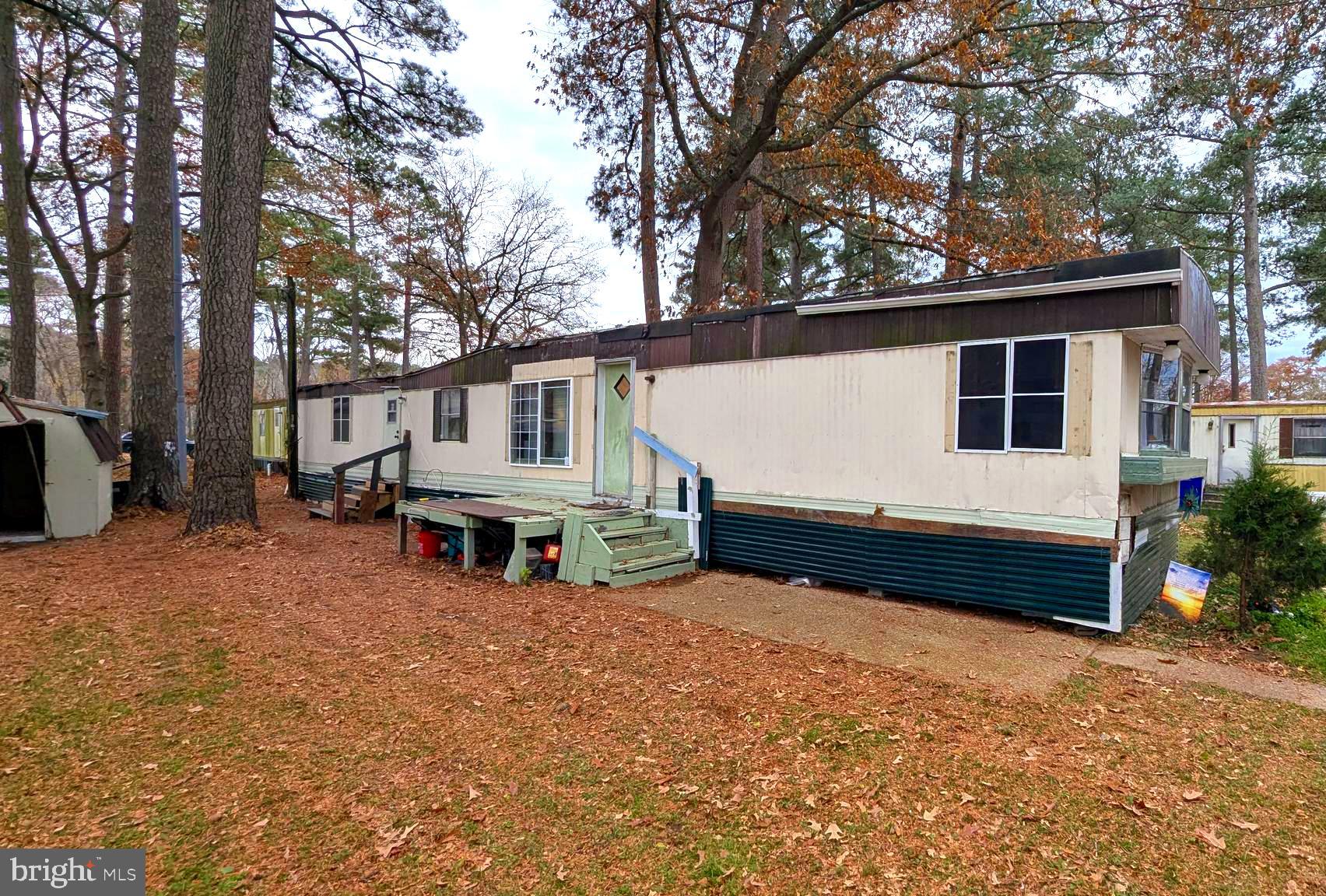 26835 Walker Road, Unit 56043 Seaford, DE 19973 - Photo 2 of 11 a view of a house with a yard and wooden fence