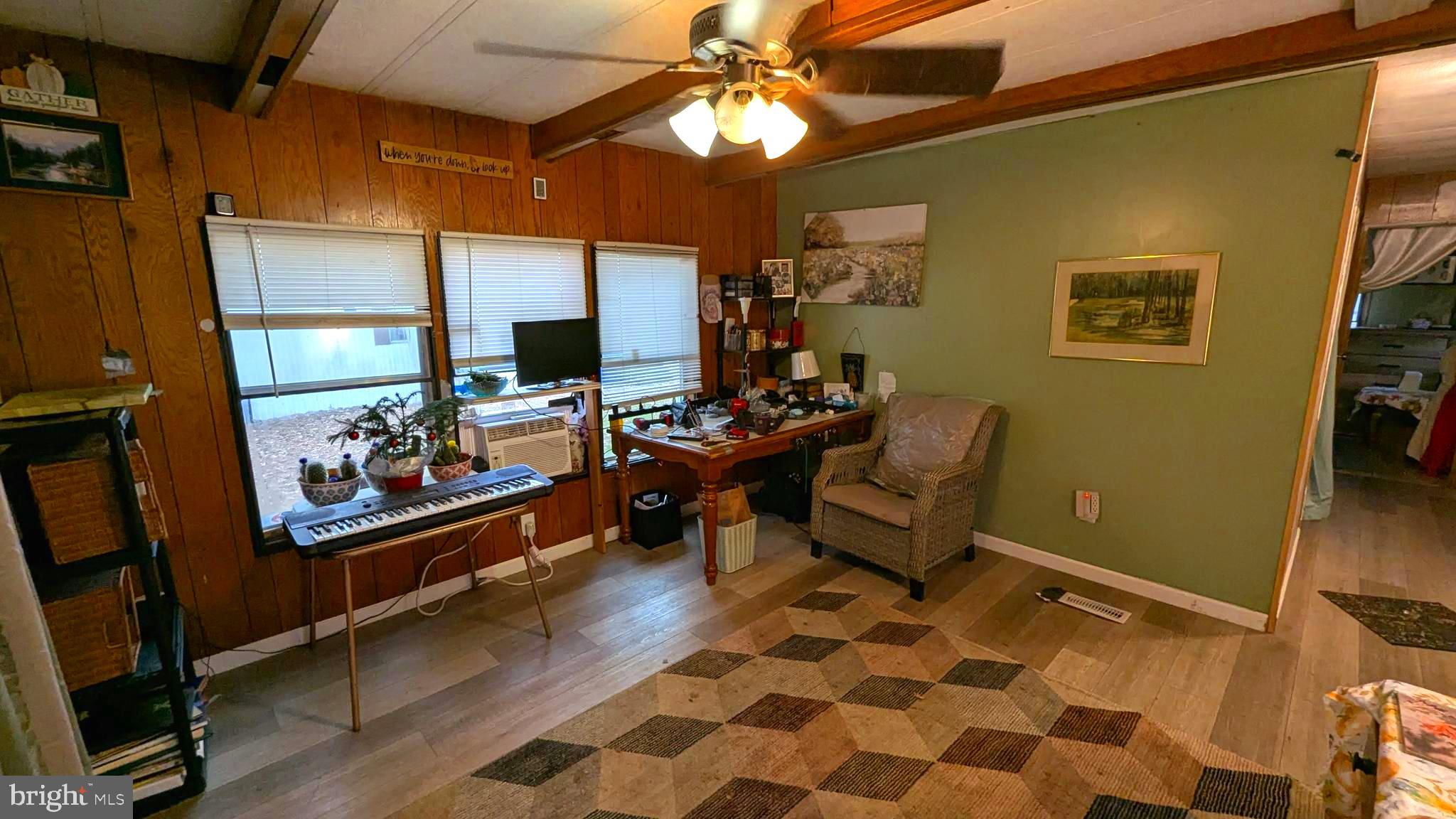 26835 Walker Road, Unit 56043 Seaford, DE 19973 - Photo 5 of 11 a living room with furniture and a flat screen tv