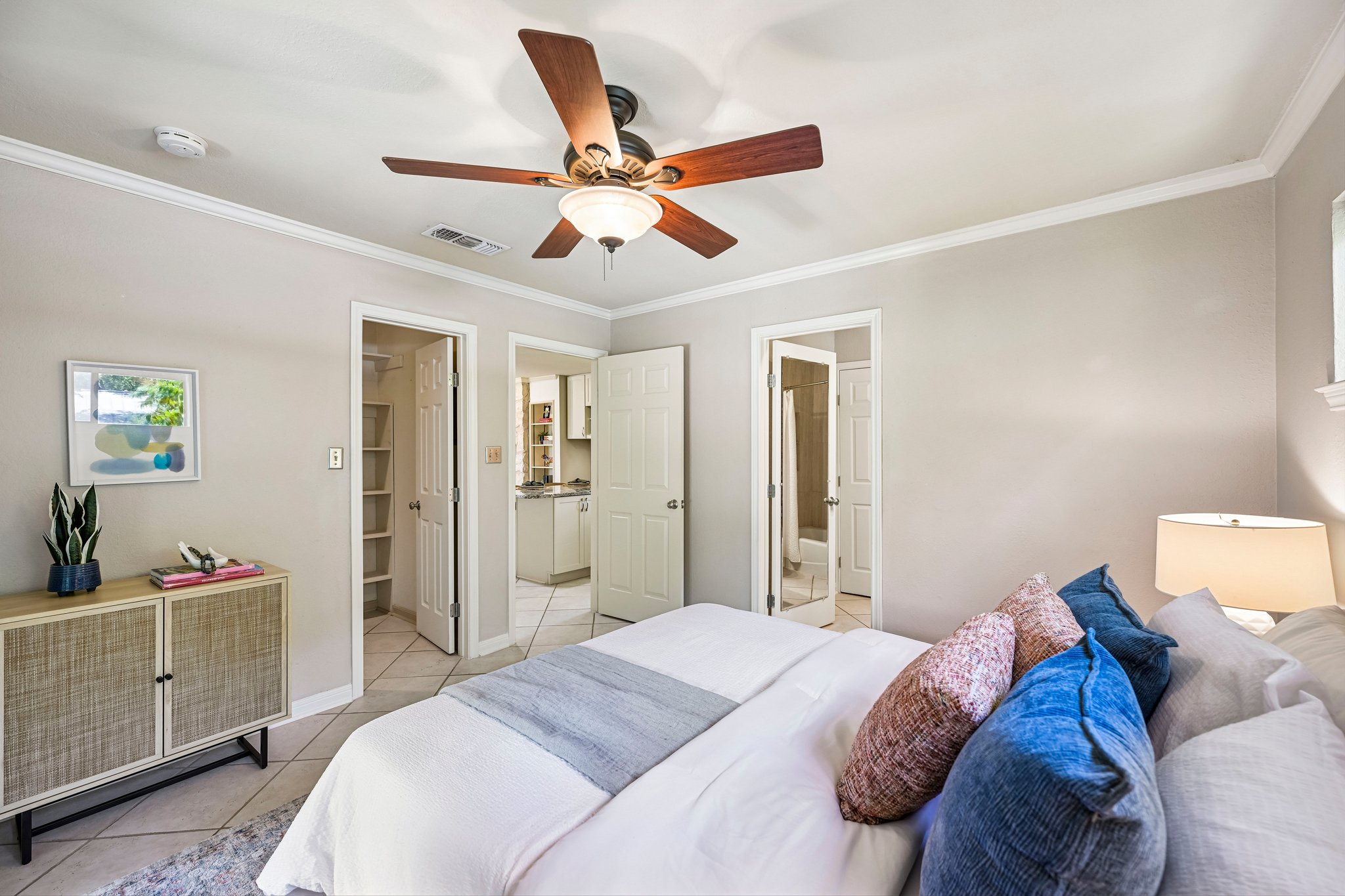 2412 Enfield Road, Unit 8 Austin, TX 78703 - Photo 20 of 34 The bedroom is surprisingly substantial for a 669 sf condo, with room for a full bedroom setup, crown molding, ceiling fan, closet storage, and direct access to the bath.