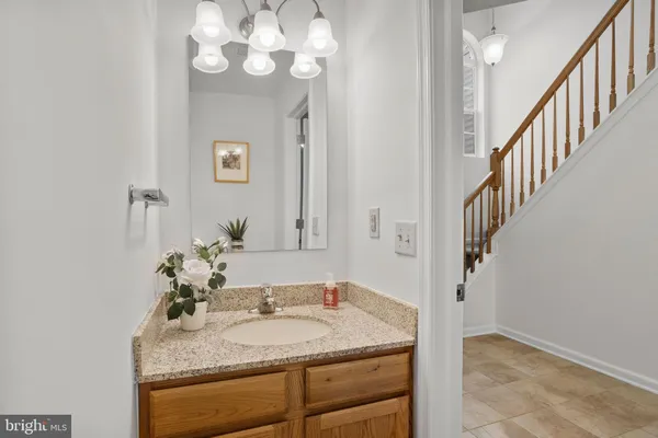 a bathroom with a granite countertop sink a mirror and a vanity