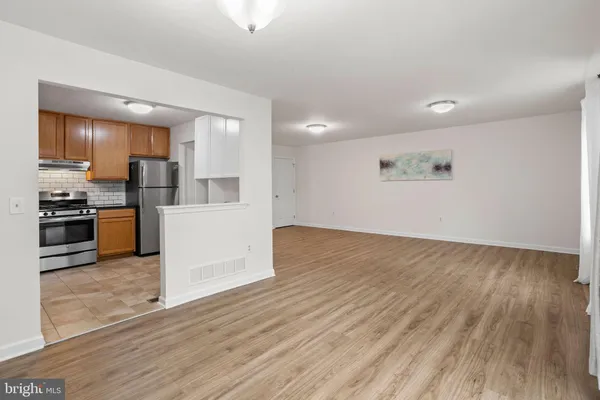 a view of a kitchen with wooden floor and electronic appliances