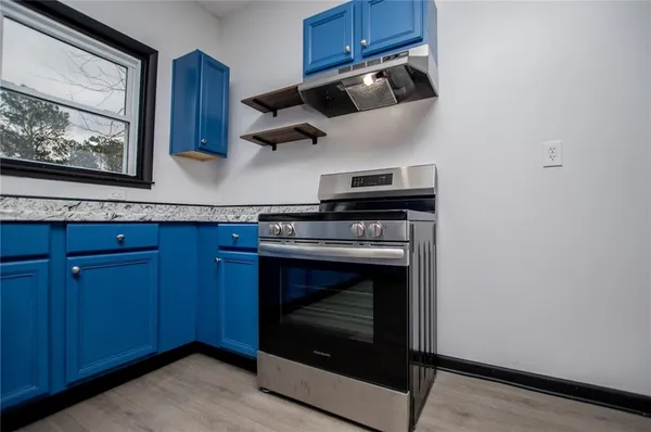 a stove top oven sitting inside of a kitchen