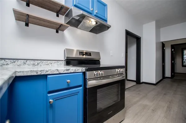 a kitchen with stainless steel appliances granite countertop a stove and a sink