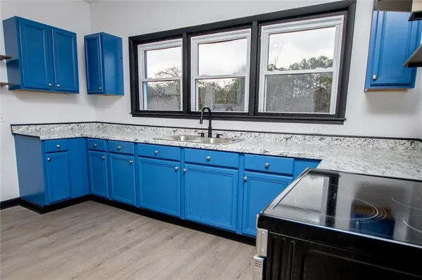 a kitchen with a sink and wooden cabinets