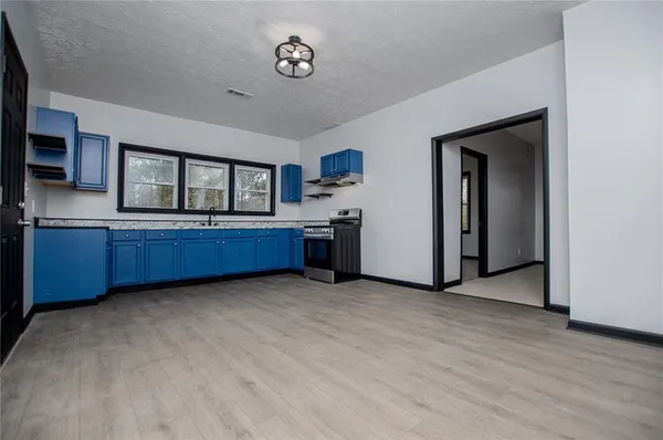 a view of a kitchen with a sink and cabinet