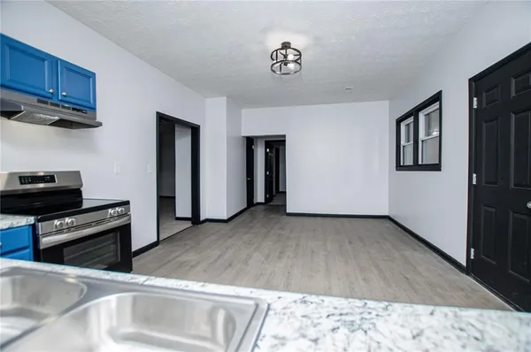 a kitchen with stainless steel appliances a stove a refrigerator and cabinets