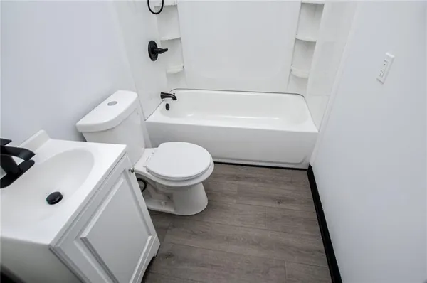 a bathroom with a bath tub with a shower