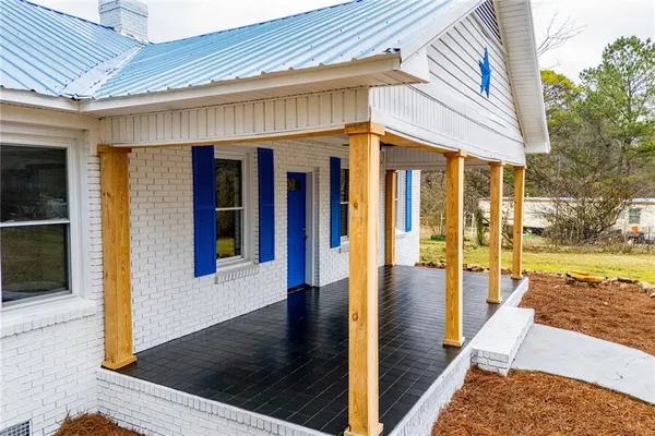 a view of a patio with wooden floor and floor to ceiling window