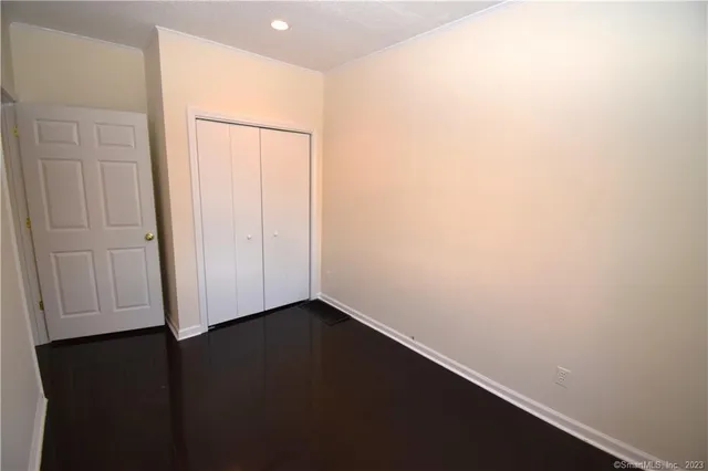 an empty room with wooden floor