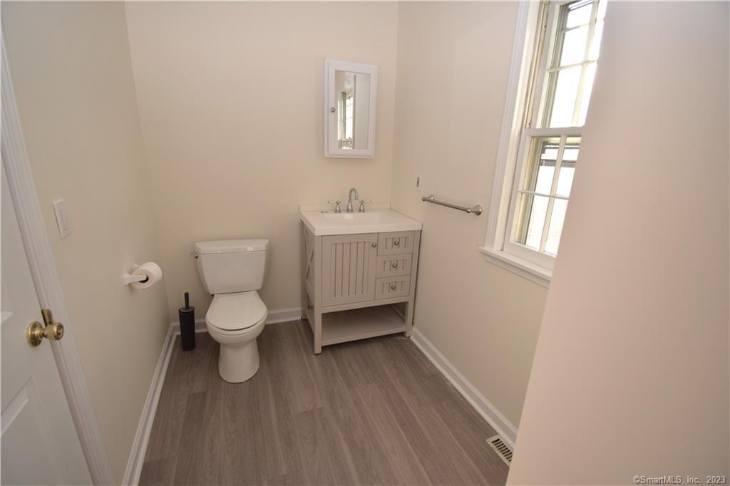 159 Main Street, Unit E Chester, CT 06412 - Photo 15 of 17 a bathroom with a toilet sink and a window