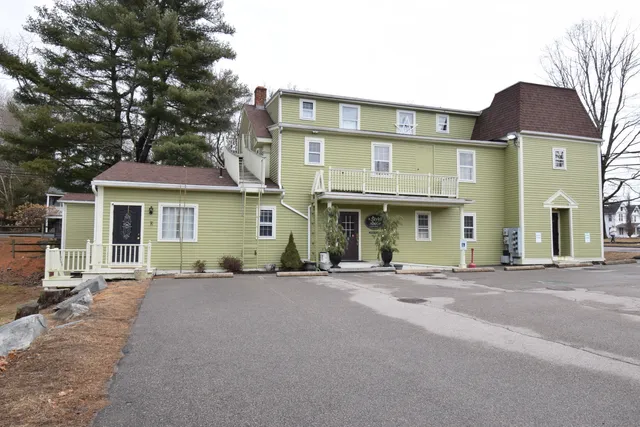 a front view of a residential apartment building with a yard
