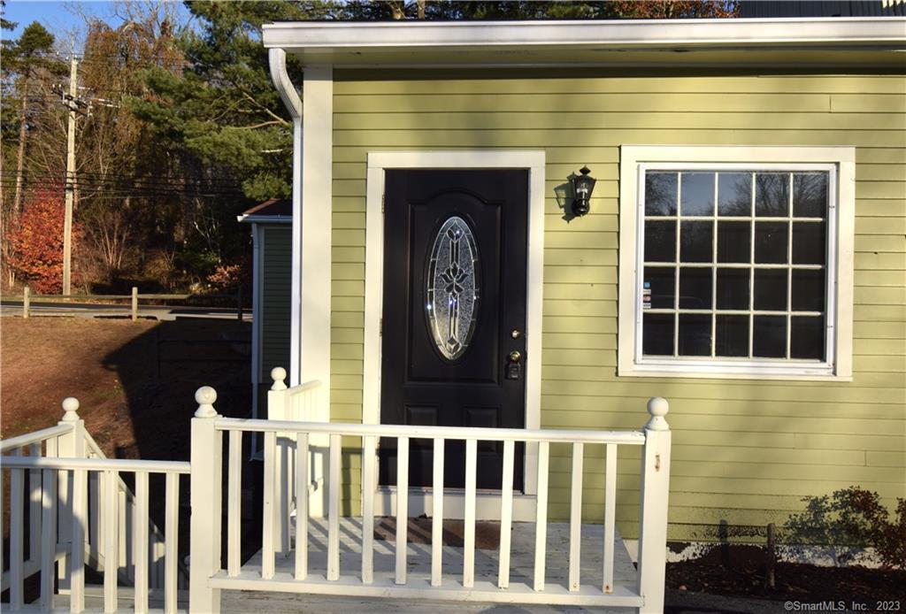 159 Main Street, Unit E Chester, CT 06412 - Photo 4 of 17 a front view of a house with a garden