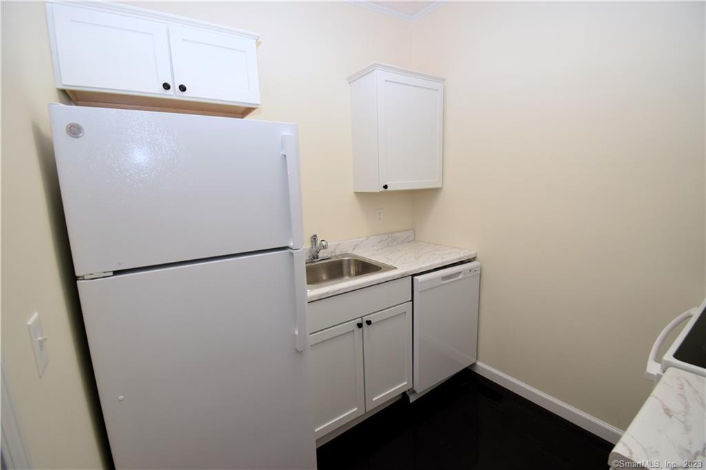 159 Main Street, Unit E Chester, CT 06412 - Photo 7 of 17 a white refrigerator freezer sitting inside of a kitchen