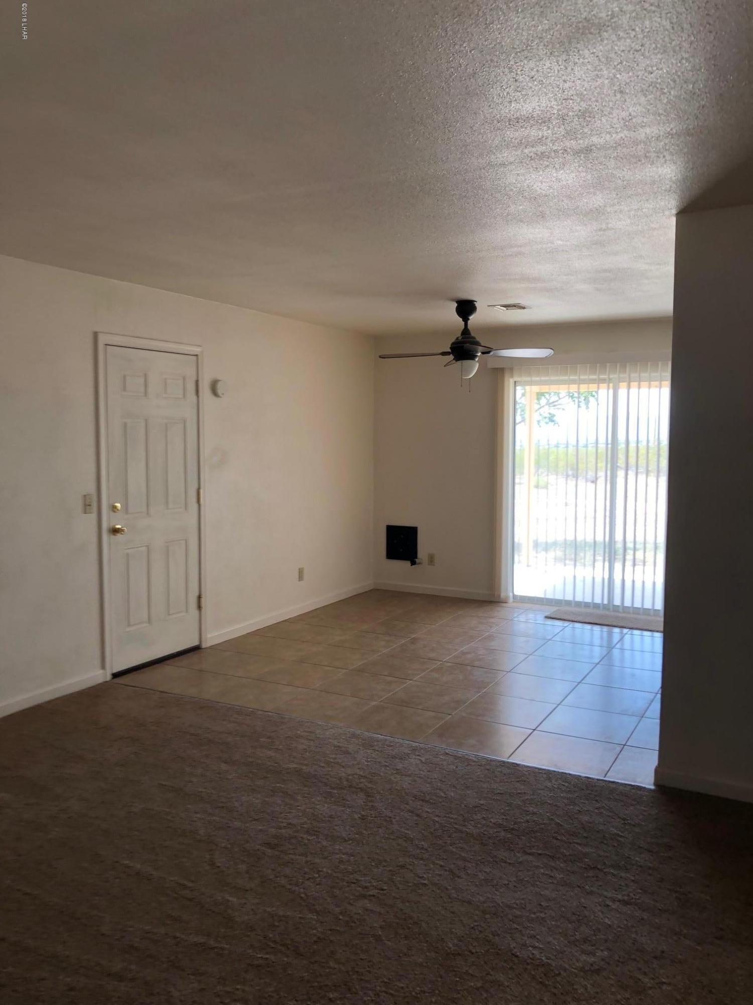 3739 Hope Road Golden Valley, AZ 86413 - Photo 12 of 26 an empty room with wooden floor and windows