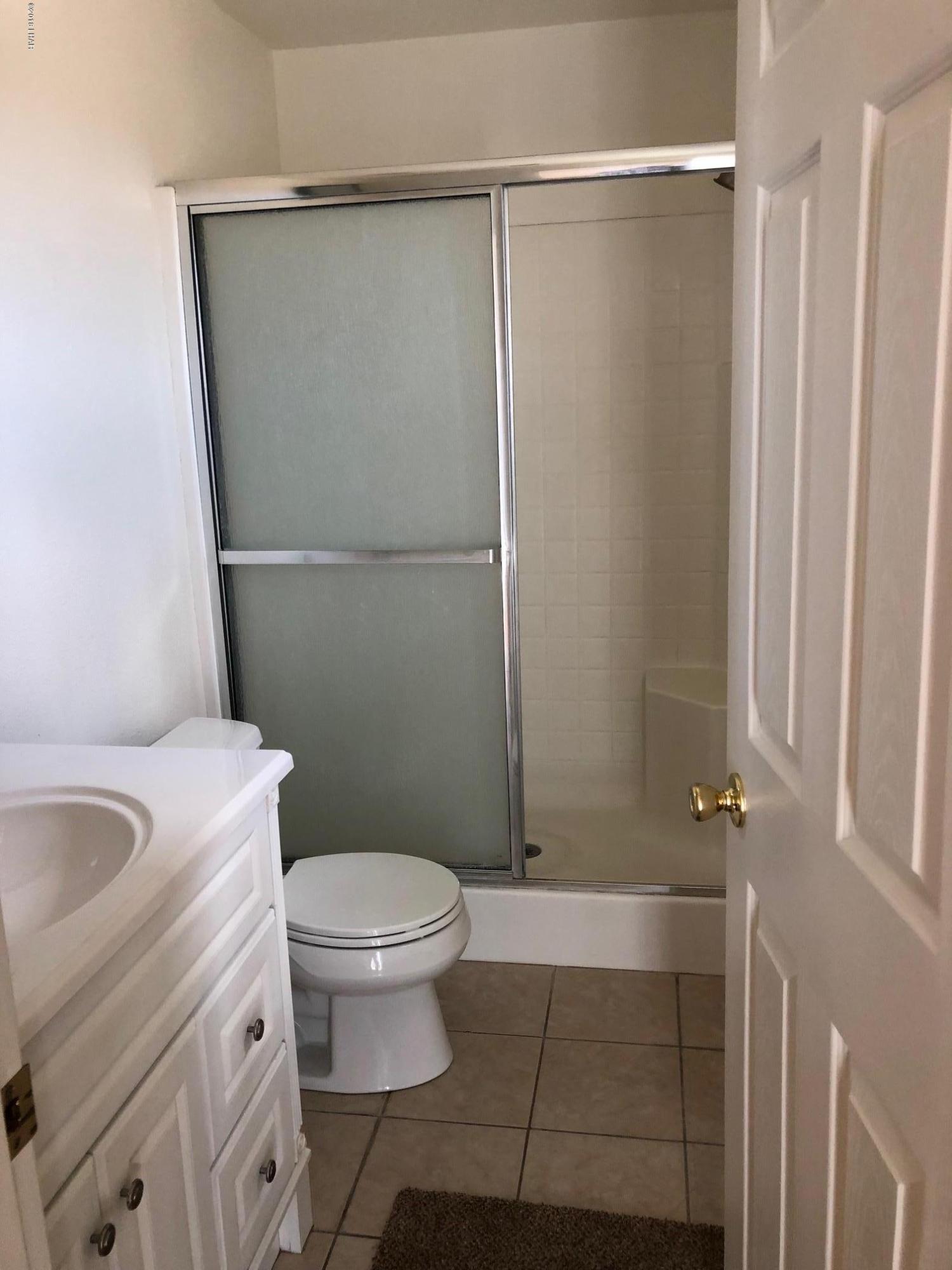 3739 Hope Road Golden Valley, AZ 86413 - Photo 19 of 26 a bathroom with a granite countertop sink toilet and shower