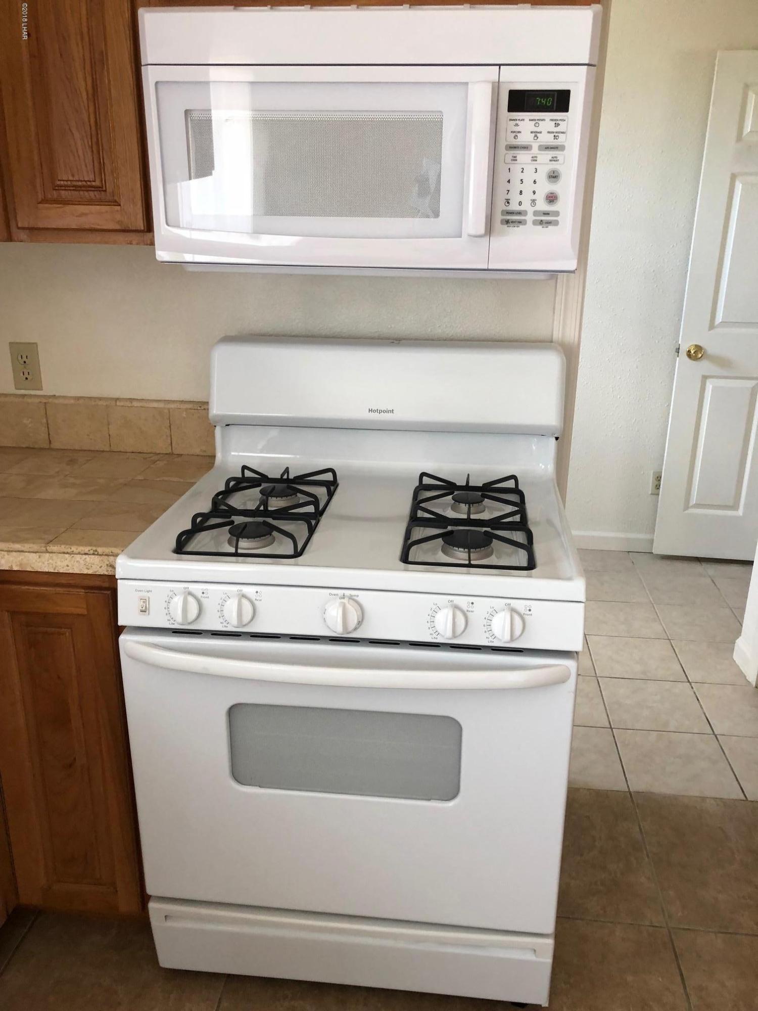 3739 Hope Road Golden Valley, AZ 86413 - Photo 6 of 26 a stove top oven sitting inside of a kitchen