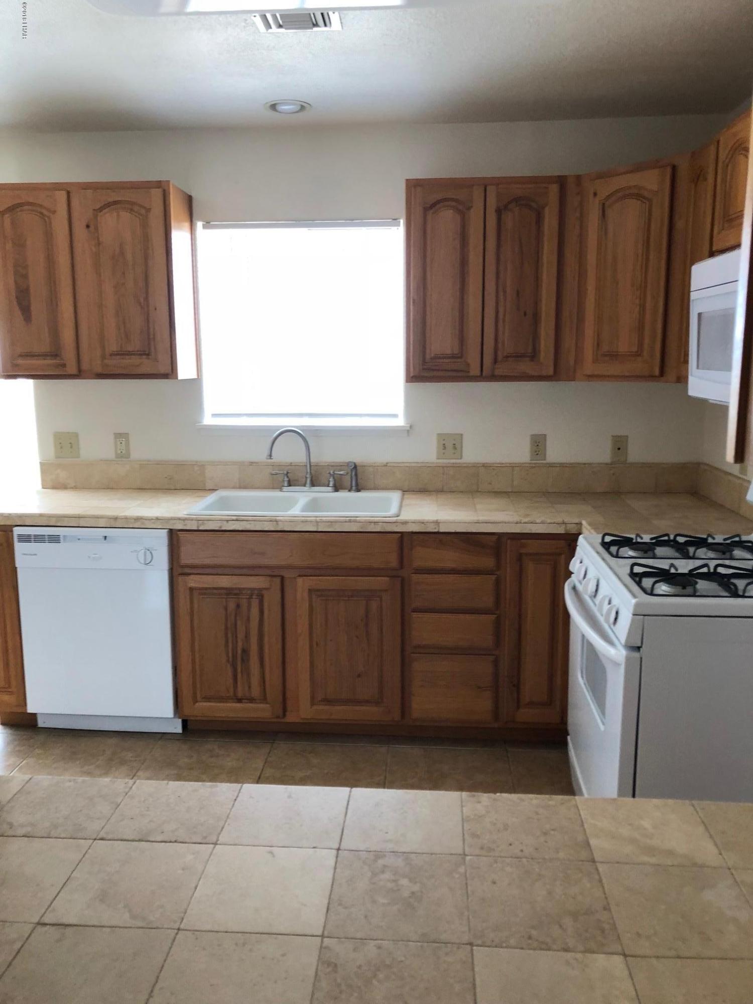 3739 Hope Road Golden Valley, AZ 86413 - Photo 7 of 26 a kitchen with a sink a stove and cabinets