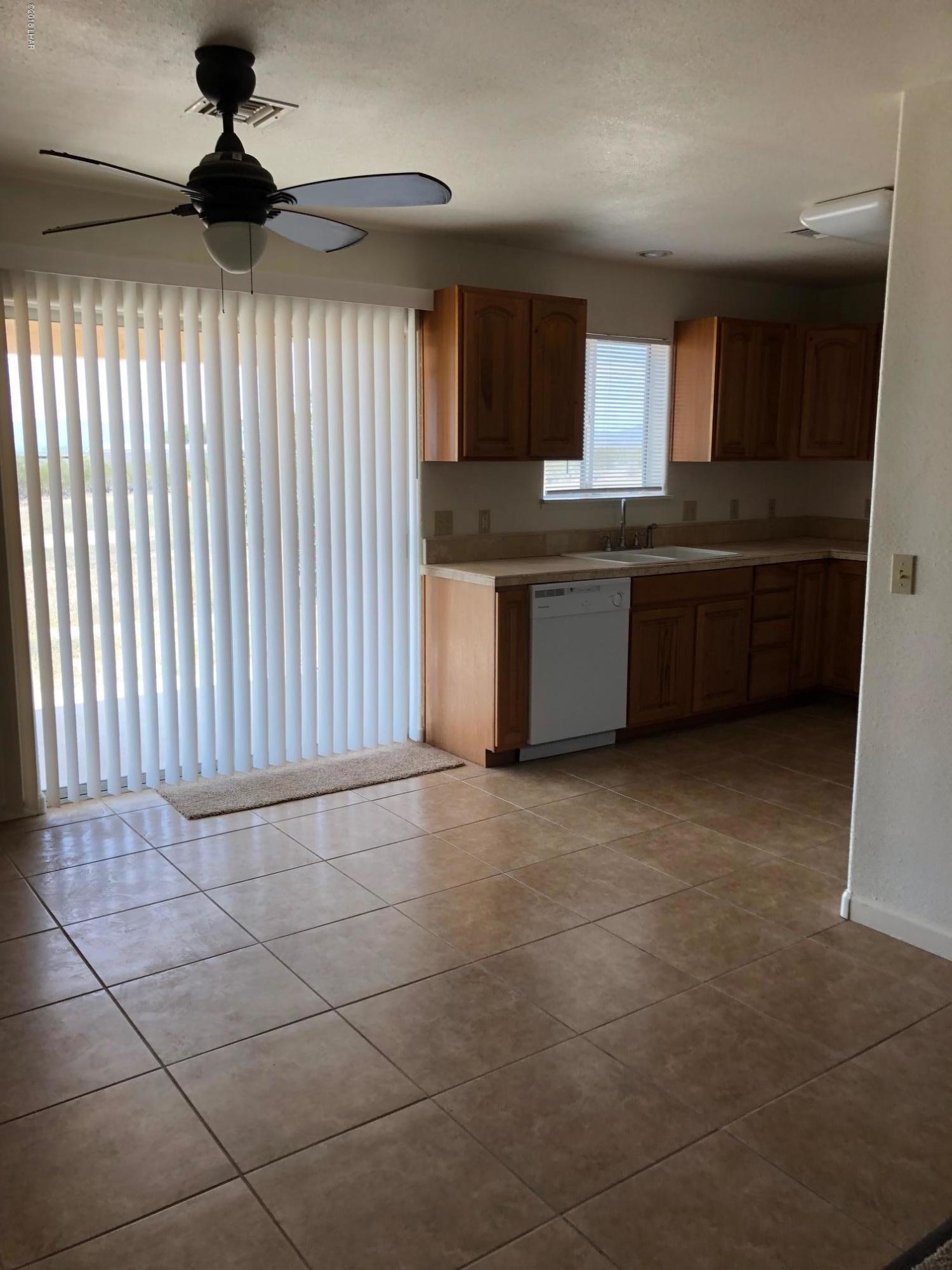 3739 Hope Road Golden Valley, AZ 86413 - Photo 8 of 26 a kitchen with granite countertop a stove a sink and a refrigerator